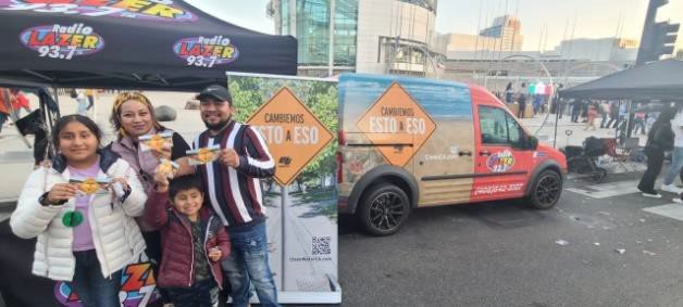 Photo of family posing by Stormwater truck and Lazer broadcasting booth